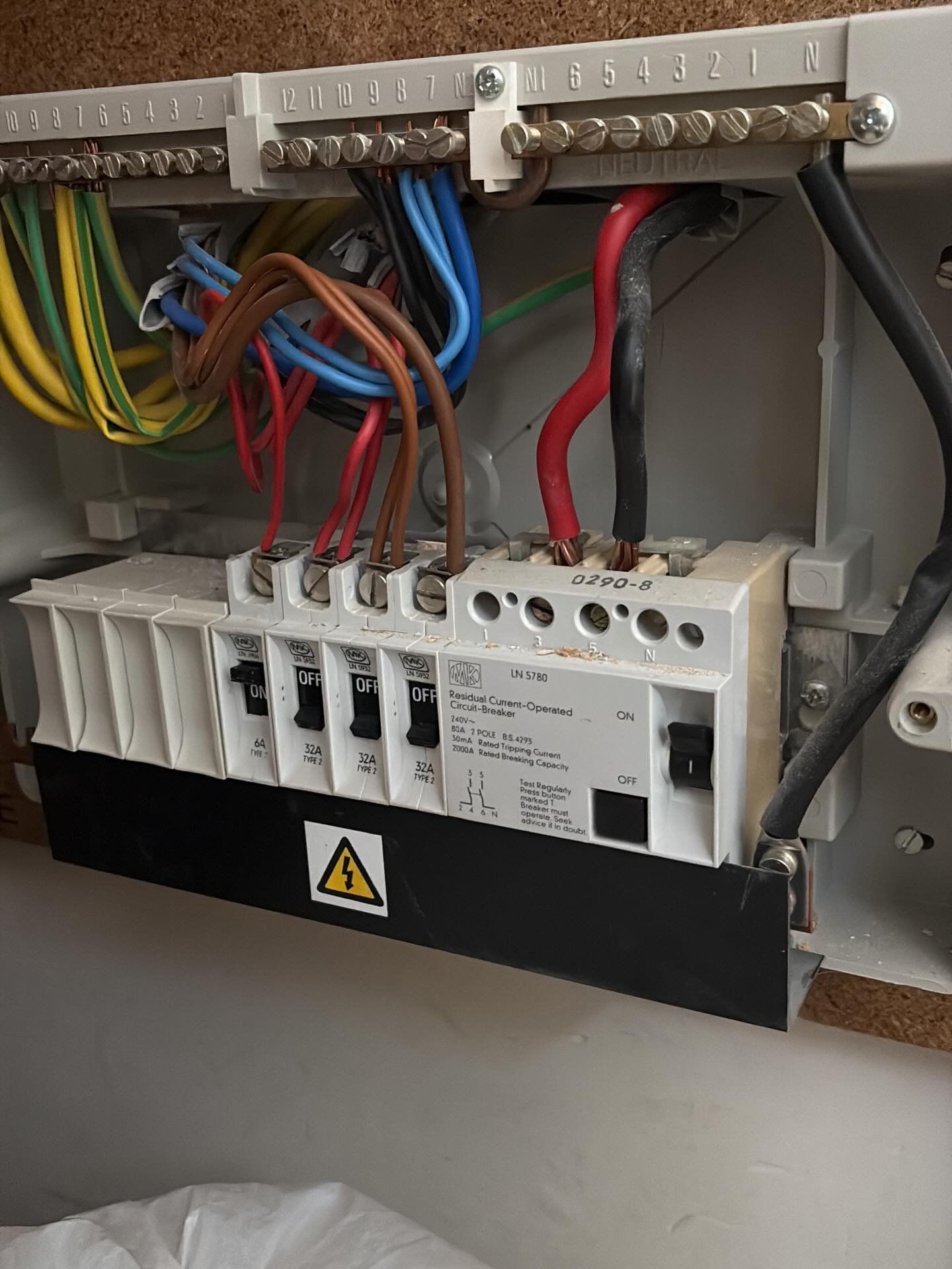 Burnt MCB and damaged busbar inside consumer unit with visible charring