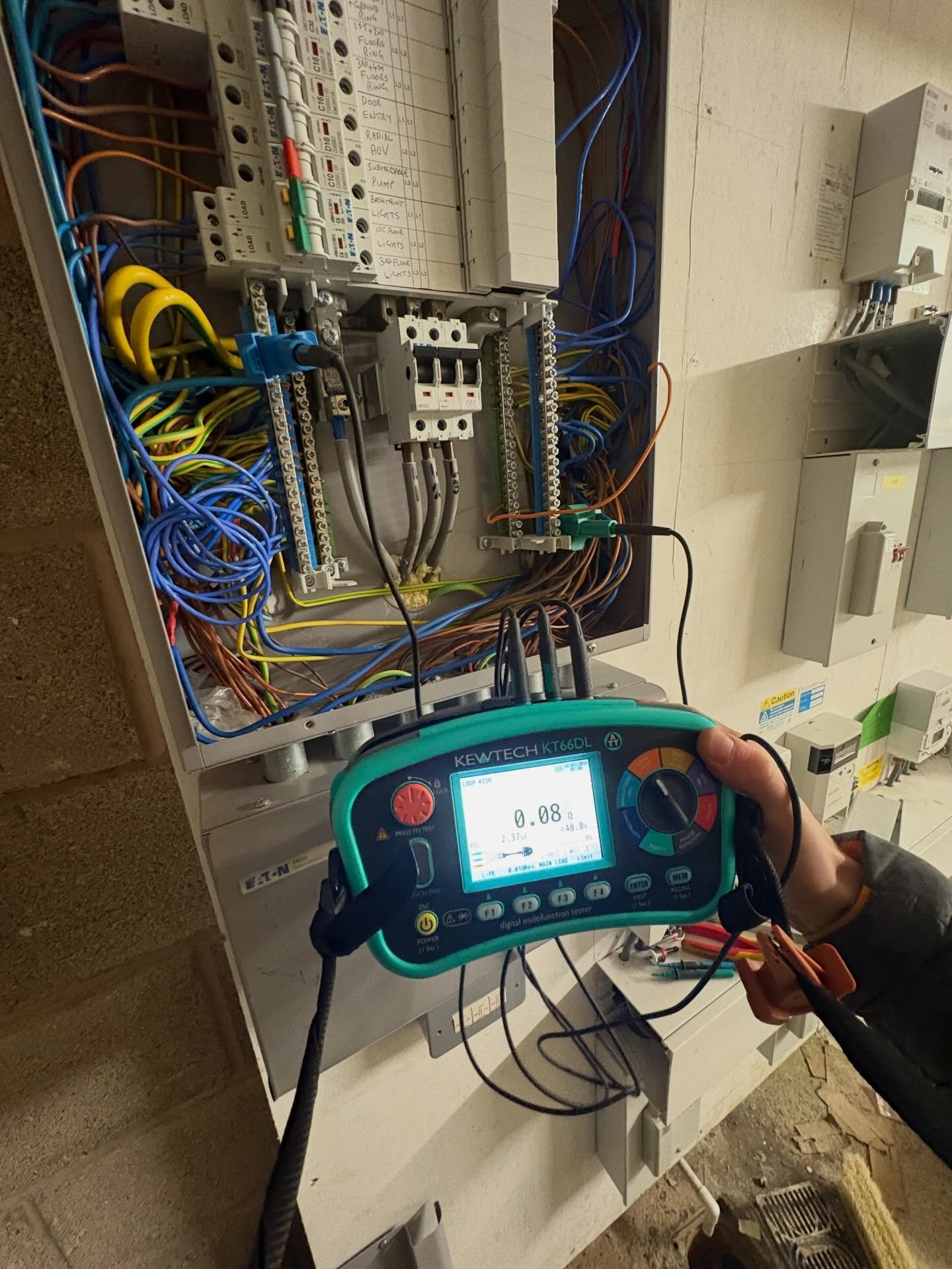 Kewtech KT66DL multifunction tester connected to commercial distribution board during EICR