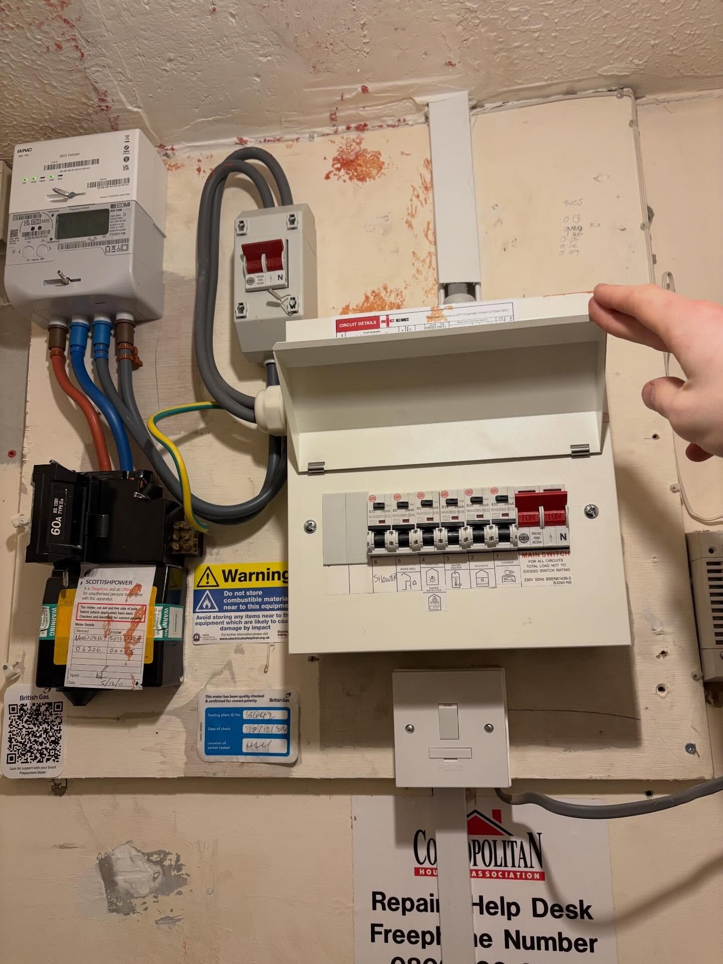 Old consumer unit with ScottishPower meter and 60A service cut-out before upgrade