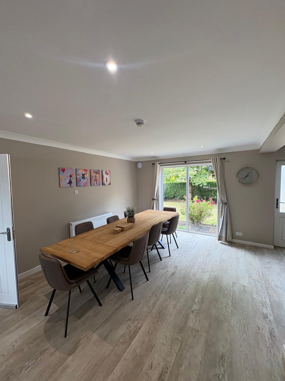 Open-plan dining room with recessed LED downlights and ceiling-mounted smoke detector