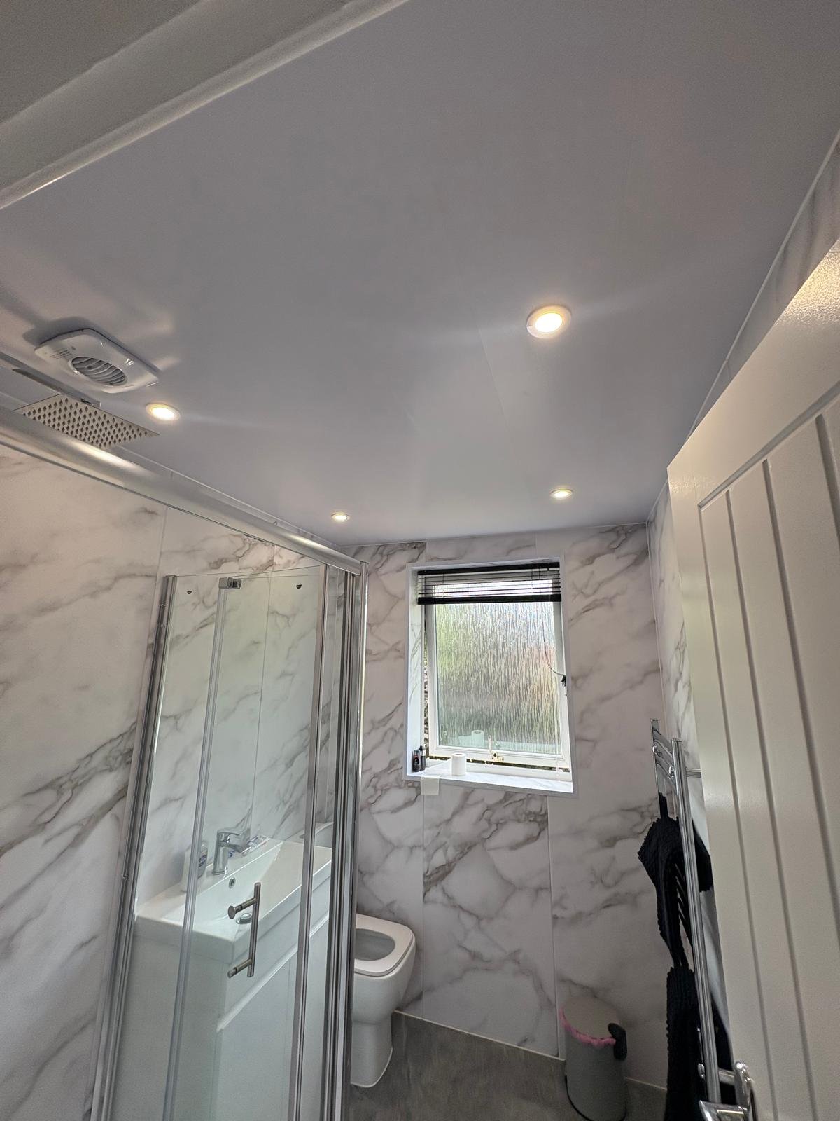 Shower room with four recessed LED downlights and ceiling extractor fan